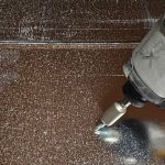 A nut setter in an impact driver driving a hex head screw into rectangular duct